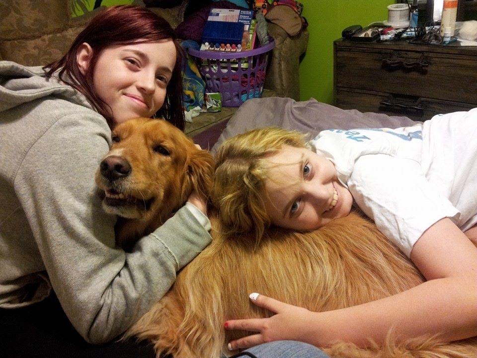 image of Melanie and Rosie Albright with golden retriever